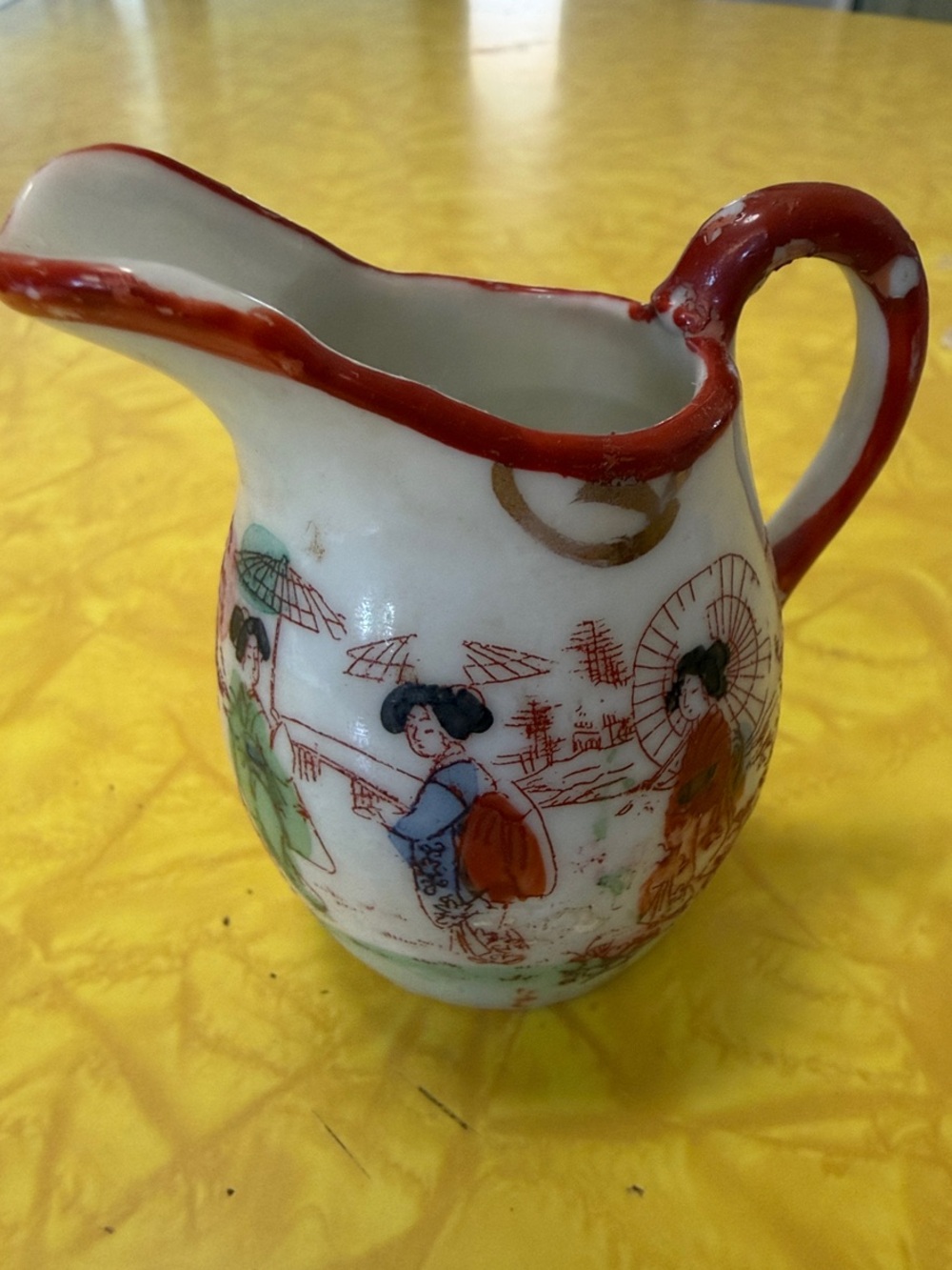 Vintage White Porcelain Pitcher with Red Trim and Multicolor Figures